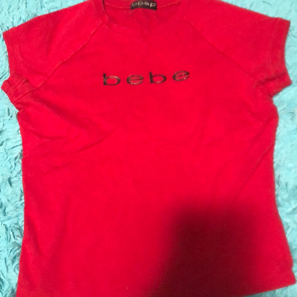 A red Bebe shirt
